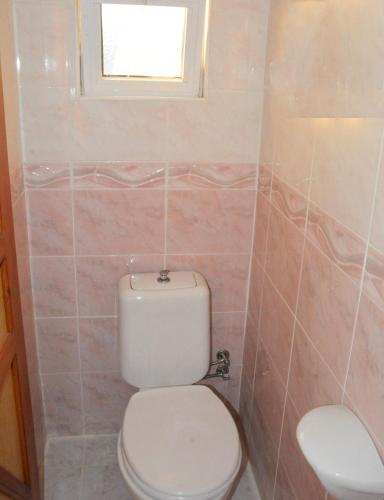 a bathroom with a toilet and a window at Villa Splash in Boğaz