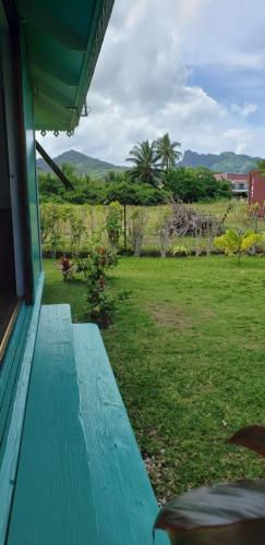 a blue bench sitting on the porch of a house at "Terevaa" 4 in Fare