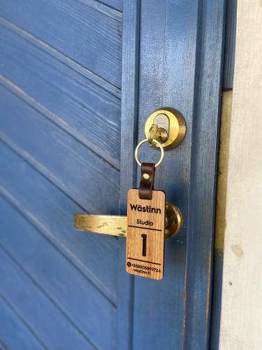 a door with a padlock on a blue door at Wästinn in Vöyri