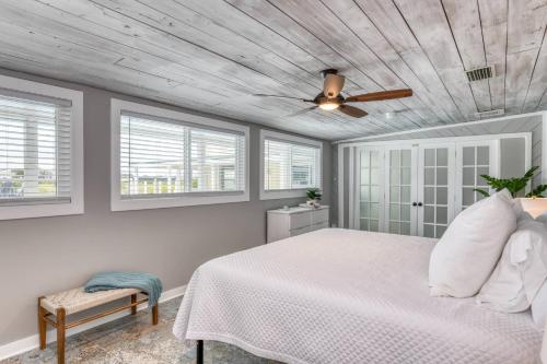 a bedroom with a white bed and a ceiling fan at Sunset Dreams in Saint Augustine