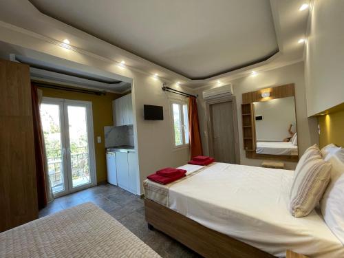 a bedroom with a large bed with red towels on it at Stella Apartments in Petra