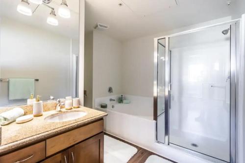 a bathroom with a sink and a shower with a glass door at Luxury 2bedroom 2bath Santa Monica in Los Angeles