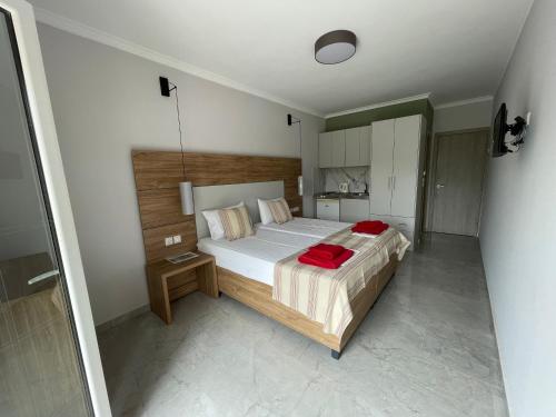 a bedroom with a large bed with red sheets at Stella Apartments in Petra