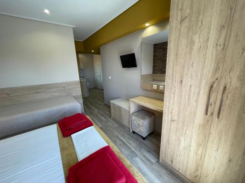 a room with a bedroom with a bed and a tv at Stella Apartments in Petra