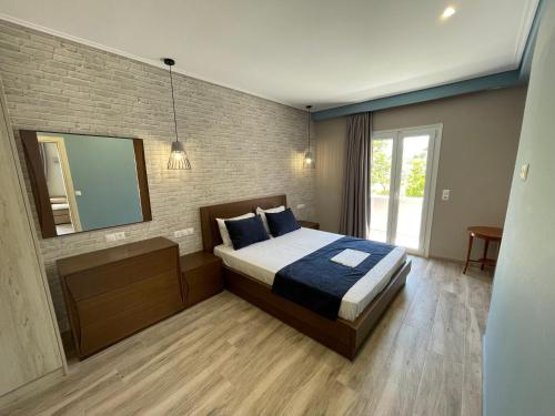 a bedroom with a bed and a brick wall at Stella Apartments in Petra