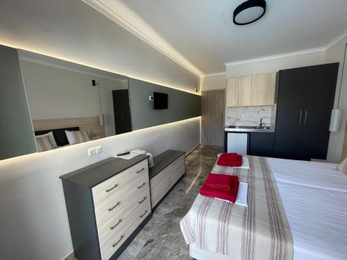 a bedroom with a bed and a dresser in it at Stella Apartments in Petra