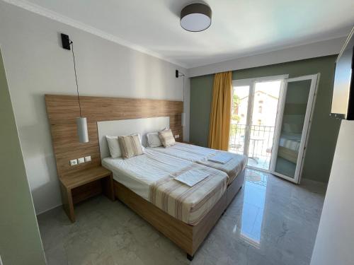 a bedroom with a large bed and a large window at Stella Apartments in Petra