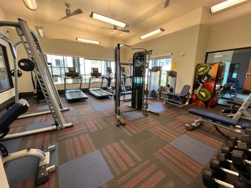 a gym with several treadmills and machines at Houston Airport Stay with Fast Wifi & Free Parking in Houston