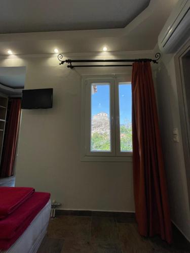 a bedroom with a window with a view at Stella Apartments in Petra