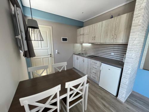 a kitchen with a table and chairs in a room at Stella Apartments in Petra