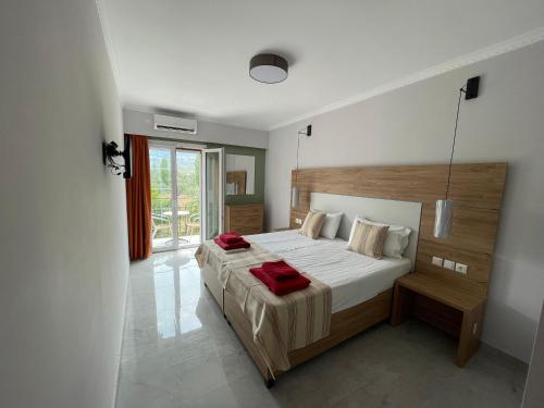 a bedroom with a bed with a red blanket on it at Stella Apartments in Petra