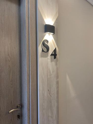 a light with the number four on a door at Stella Apartments in Petra