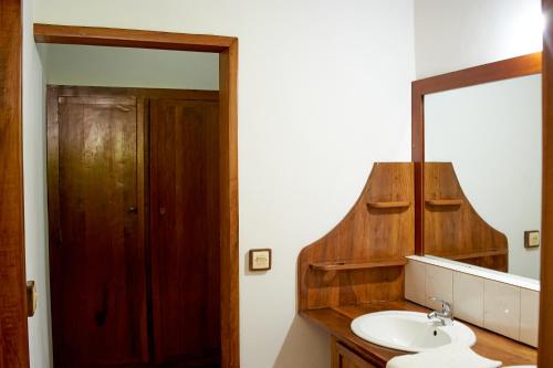 a bathroom with a sink and a mirror at Villa MILENA in Nosy Be