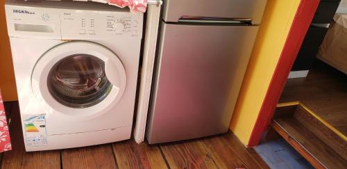 a washing machine sitting next to a refrigerator at "Terevaa" 4 in Fare