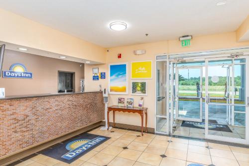 a lobby of a dogs inn with a sliding glass door at Days Inn by Wyndham Coliseum Montgomery AL in Montgomery