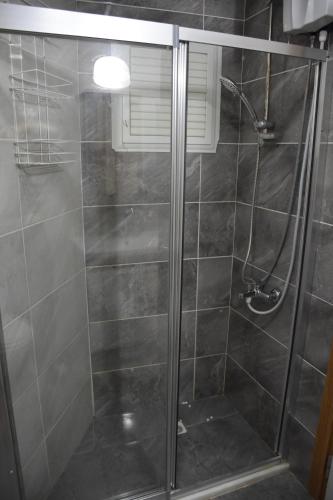 een badkamer met een douche en een glazen deur bij Serenity Apart in Antalya