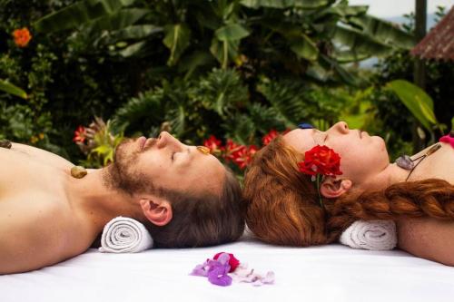 a man and a woman laying on the ground at Cabaña Mikhuna, Bienestar en las montañas !!! in Anolaima