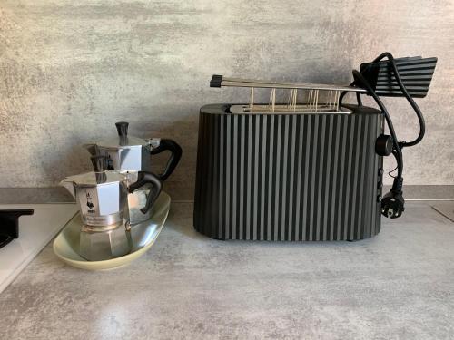 a coffee maker and a heater on a counter at Stadia Suite in Verona