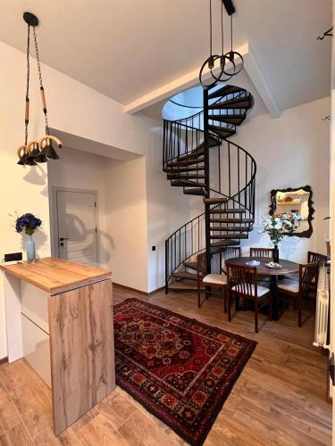 a living room with a spiral staircase and a table at STATION BOUTIQUE HOTEL in Gyumri