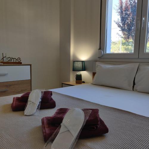 a bedroom with a large bed with towels on it at Mare Monte Luxury Apartments 4 in Kassandria