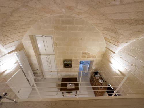 a spiral staircase in a building with an archway at Antica Cisterna di Lecce in Lecce