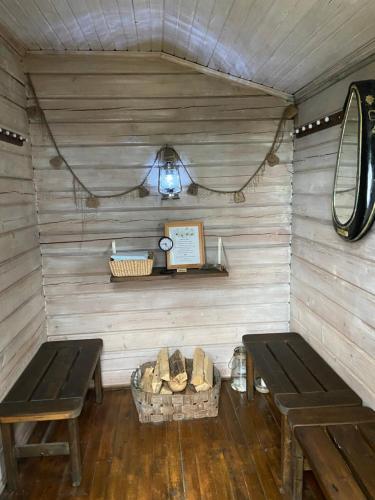 a room with two benches and a table and a basket at Wästinn in Vöyri