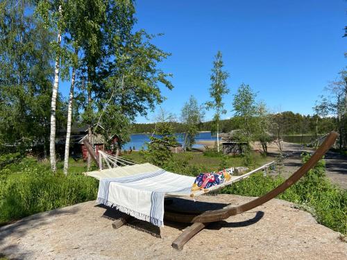 a hammock sitting on a rock in a field at Wästinn in Vöyri
