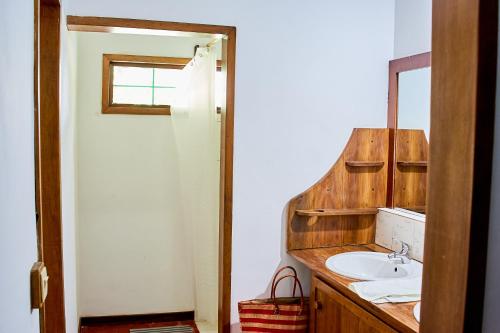 a bathroom with a sink and a mirror at Villa MILENA in Nosy Be