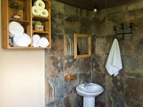 a bathroom with a sink and a toilet and towels at Comfortable 10 guest villa in a Big 5 Game Reserve in Dinokeng Game Reserve