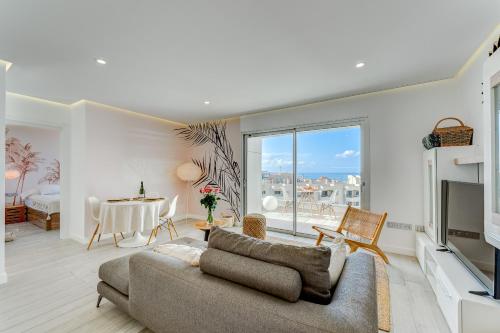 a living room with a couch and a table at OCEAN GARDEN Sunset & Sunrise - heated pool - AC - lounge zone in Adeje
