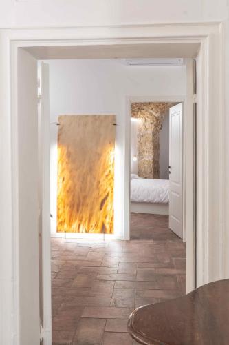 a living room with a painting on the wall at Calderai 82 suites 1 e 2 in Palermo