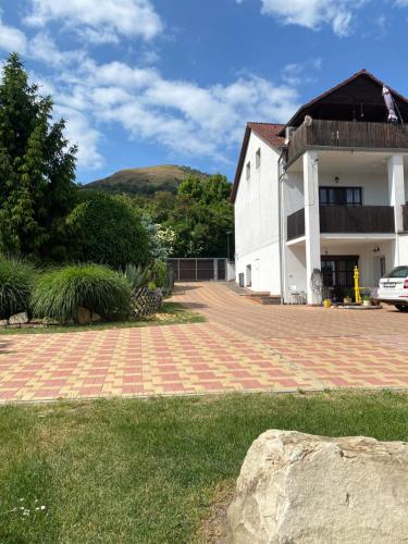 a house with a brick driveway next to a building at Penzion Labská Vyhlídka in Litoměřice