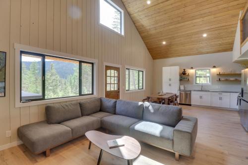 a living room with a couch and a table at Lakeside Cabin with Hot Tub 3 Mi to Flathead Lake! in Lakeside