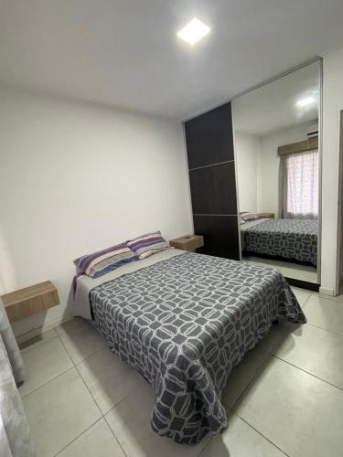 a bedroom with a bed and a large mirror at Terra in Capitán Bermúdez