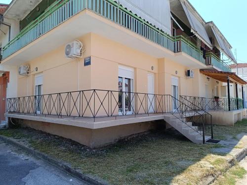 a building with a balcony on the side of it at Panos House - High Luxury Apartment in Tríkala