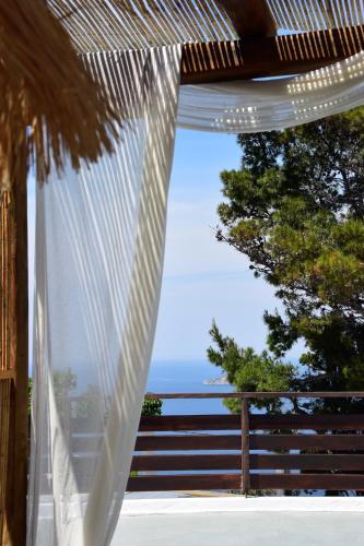 a window with a view of the ocean at Chora Suite in Alonnisos Old Town