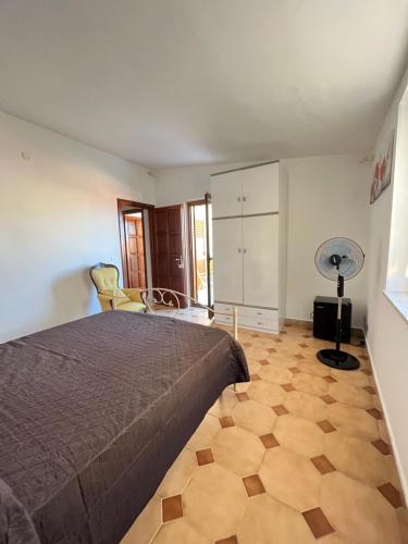 a bedroom with a bed and a wooden floor at Piccola Mansarda in Parghelia
