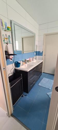 a bathroom with a sink and a mirror at Villa- suite privée avec accès sur piscine 