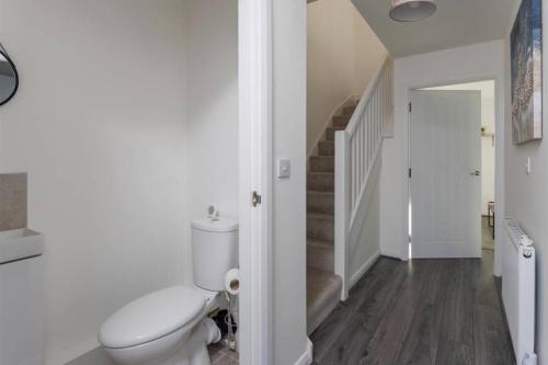 a bathroom with a toilet and a staircase at Luxury 3-Bedroom, 2-Bathroom Home sleeps 7 people in Liverpool