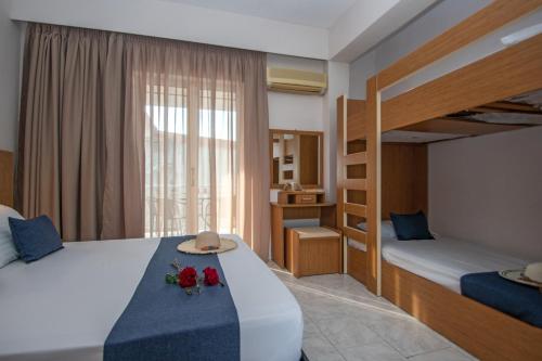 a bedroom with two beds and a bunk bed at Kozanos Studios 1 in Amoudi
