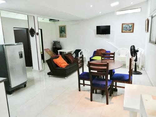 a living room with a couch and a table and chairs at Casa en Condominio Santa Helena in Yaguará