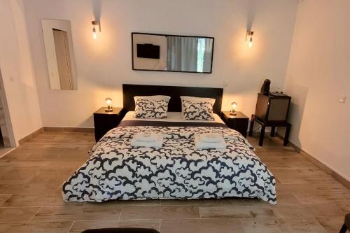 a bedroom with a bed with a black and white comforter at Village Cascais Guest House in Cascais