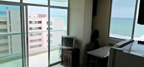 Zimmer mit einem TV auf einem Tisch und einem Fenster in der Unterkunft Apartment in Atacames in Atacames