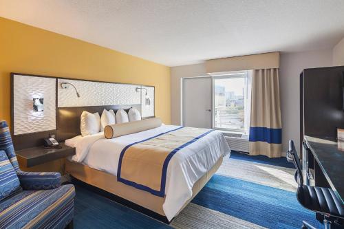 um quarto de hotel com uma cama grande e uma televisão de ecrã plano em Southbank Hotel by Marriott Jacksonville Riverwalk em Jacksonville