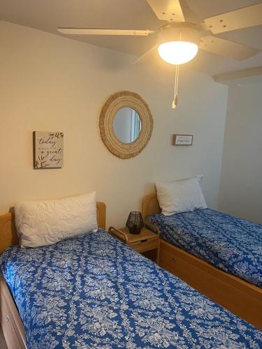 a bedroom with two beds and a mirror at Beachfront Salou apartment with sea view in Salou