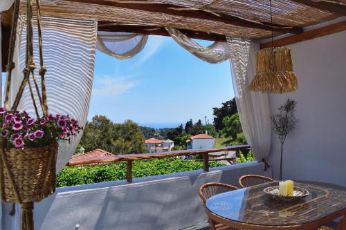 a view from the balcony of a house with a table and chairs at Chora Suite in Alonnisos Old Town