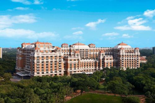 a large building with trees in front of it at ITC Grand Chola, a Luxury Collection Hotel, Chennai in Chennai