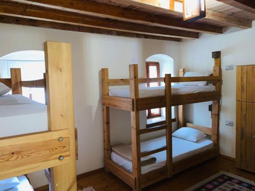 a room with three bunk beds in a house at Guest House and Hostel VAL-MAR in Gjirokastër