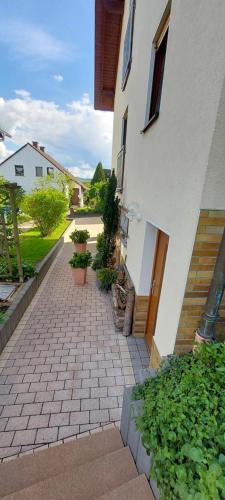 a brick walkway in front of a white building at Gästezimmer Weinberg in Steinau an der Straße