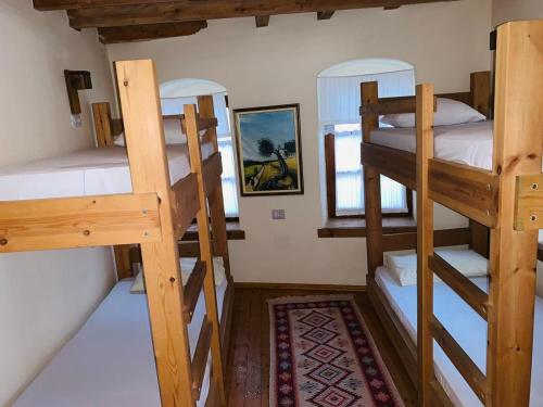 a room with three bunk beds in a house at Guest House and Hostel VAL-MAR in Gjirokastër